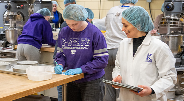 student, faculty in bake lab